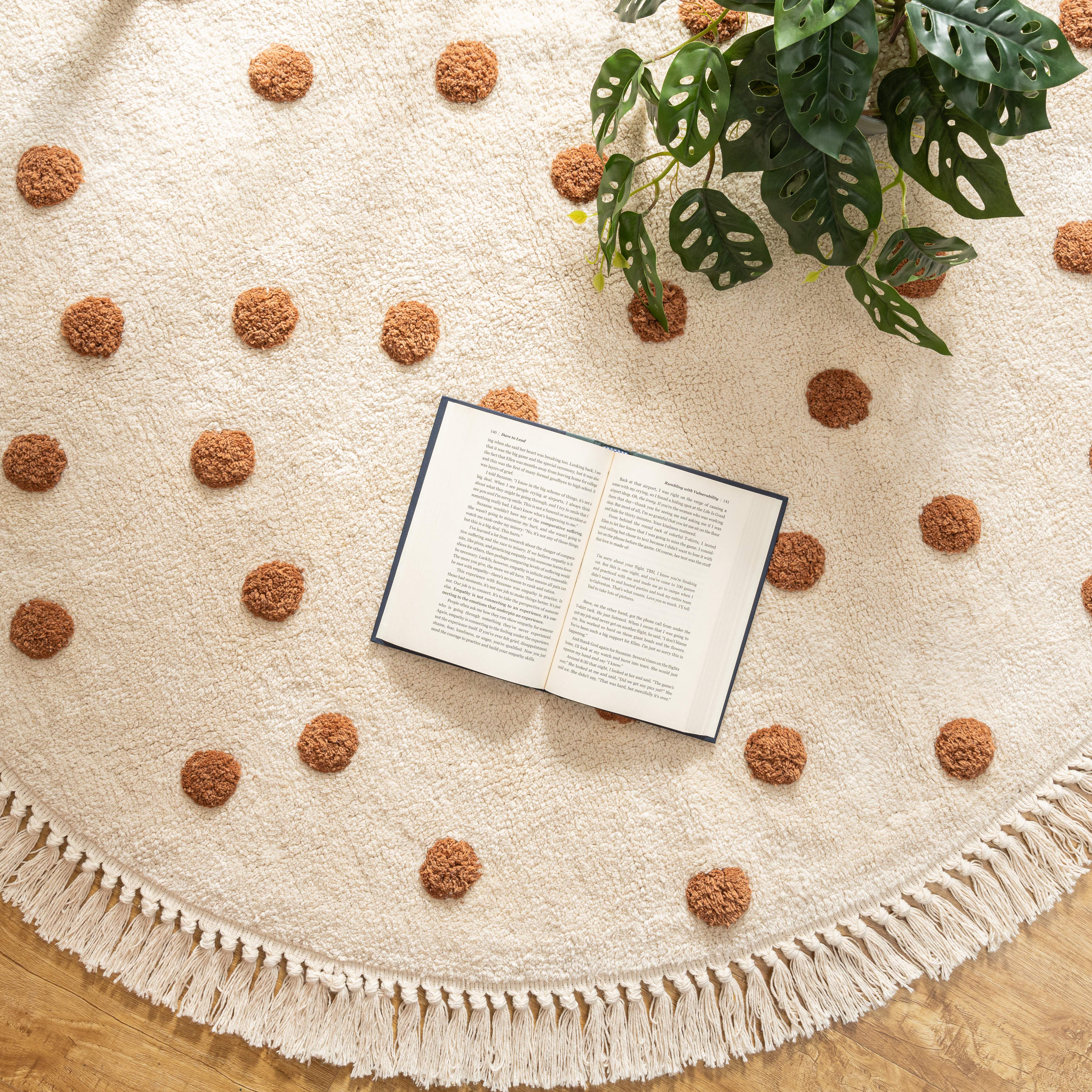 Close-up of the thickness and texture of the handmade cotton polka dot rug, with a chair resting on top for context.