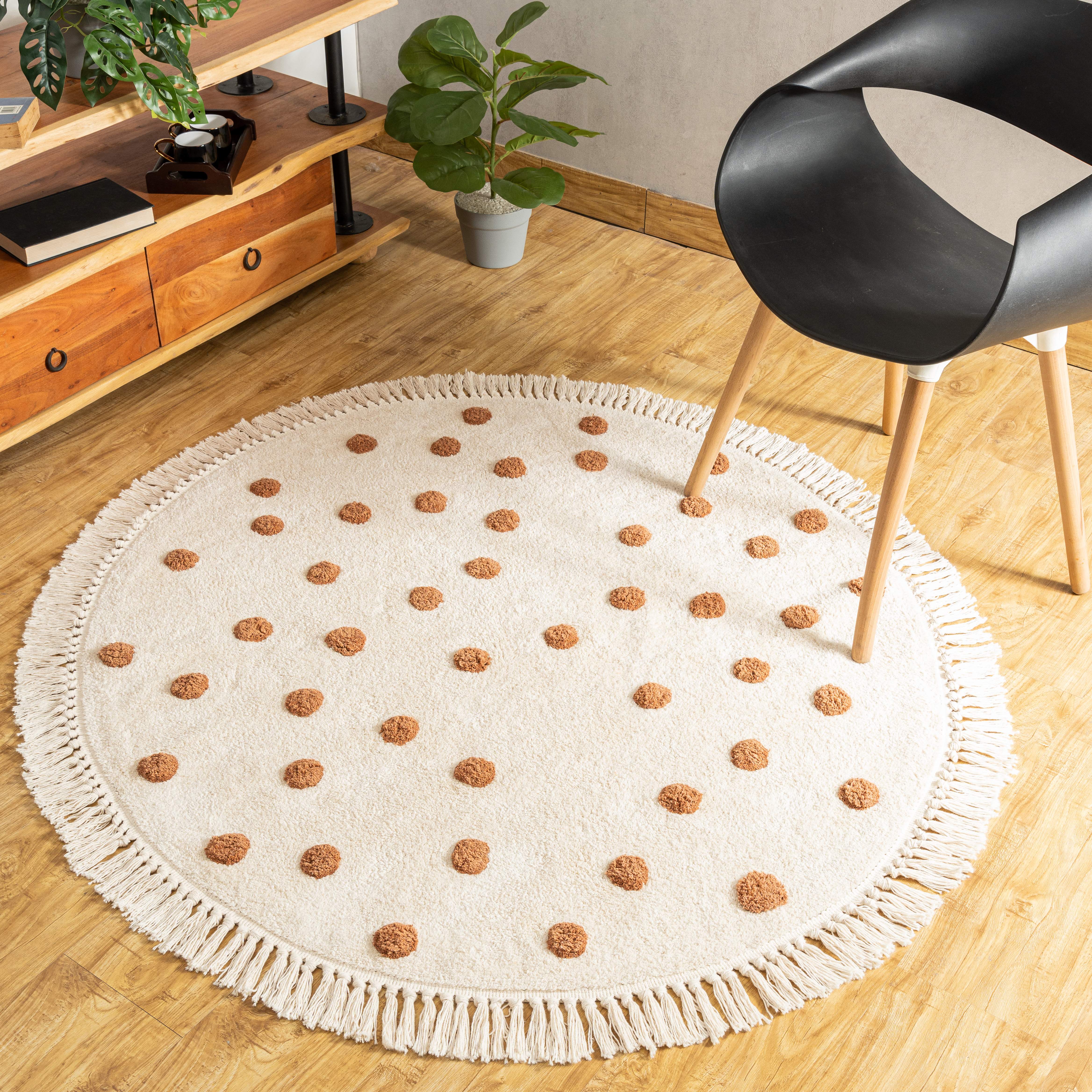 Cozy living room setting with a natural and brown handmade cotton polka dot rug with fringes as a focal point.